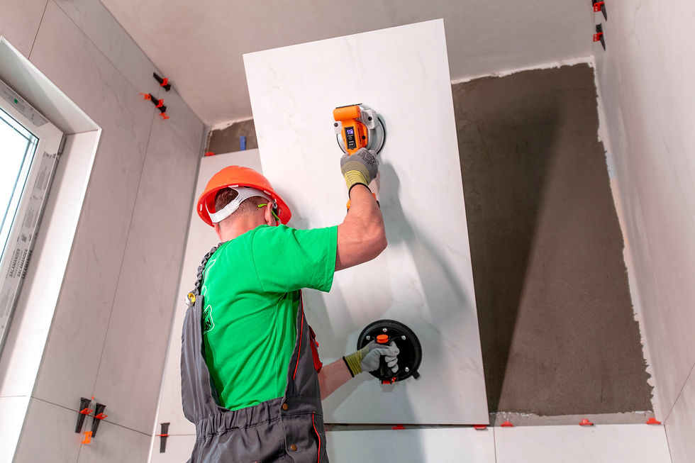 One worker is using the tile vibration tool and a heavy-duty manual cup to place a large tile
