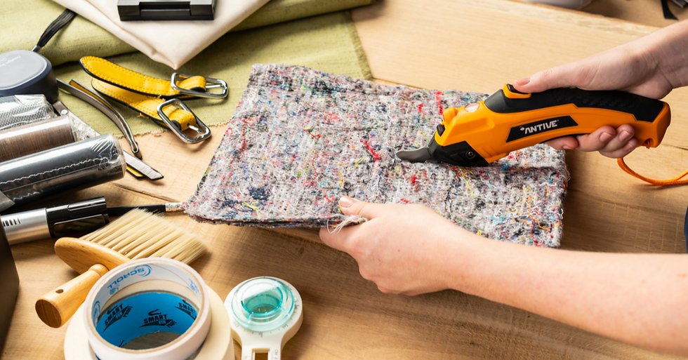 The Antive Electric scissors are cutting a piece of felt fabric.