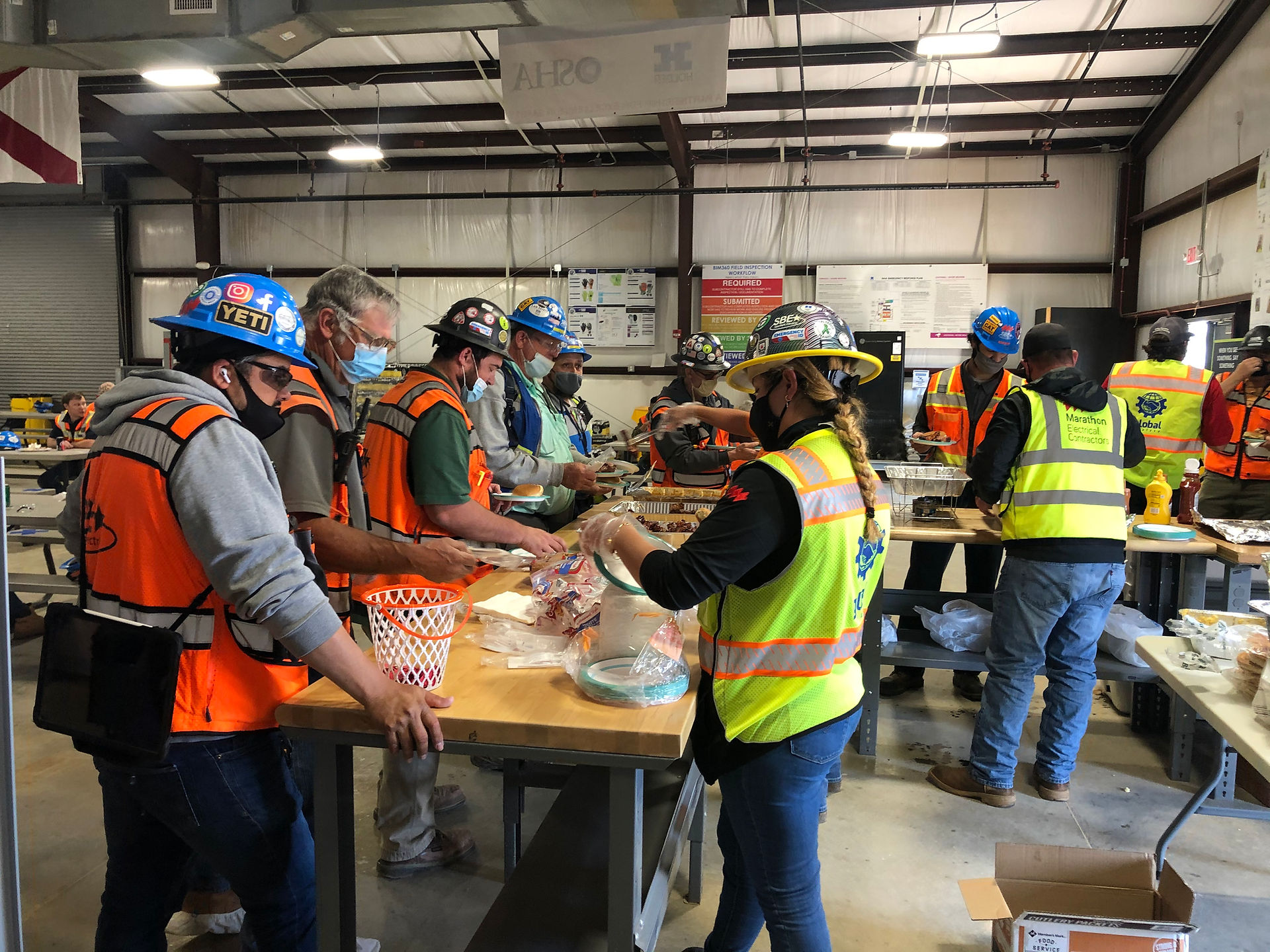 Marathon Electrical Contractor employees at Project NHA break for community lunch