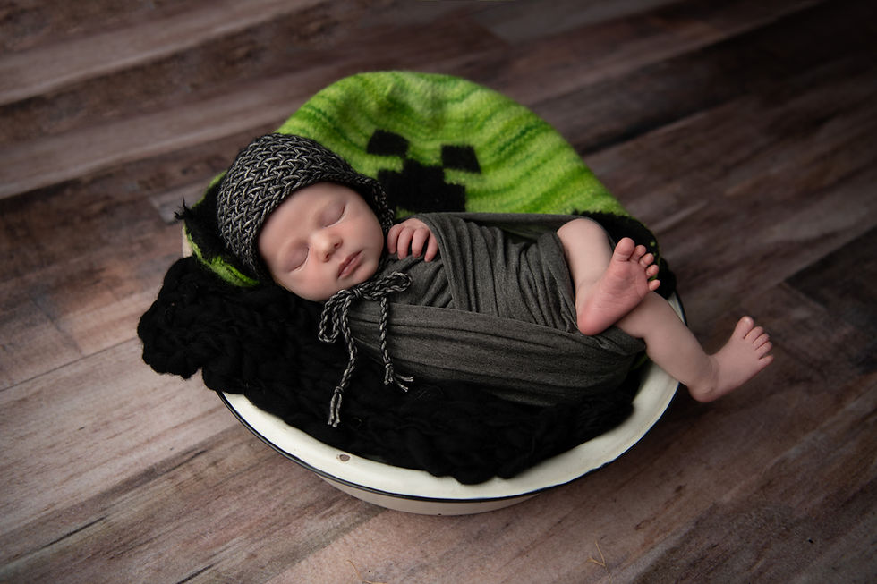 baby boy sleeping in bowl with minecraft hat