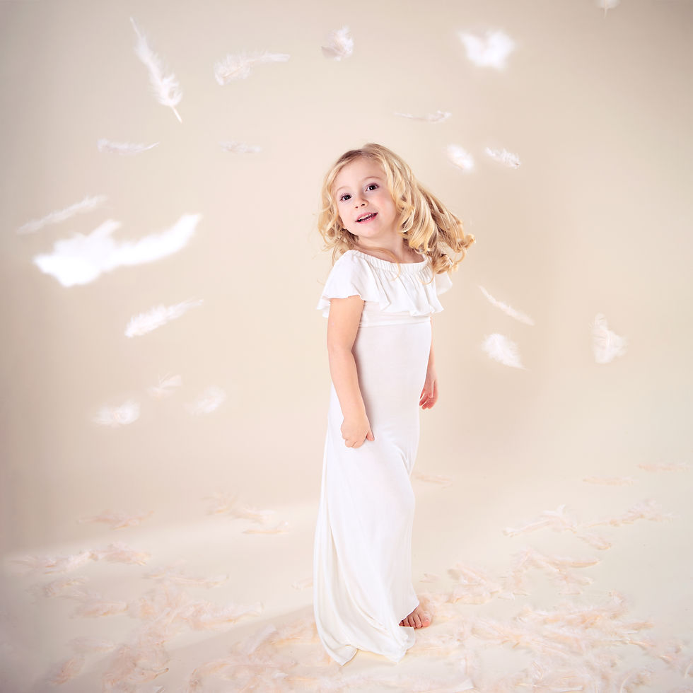 A sheep by a manger with a baby.