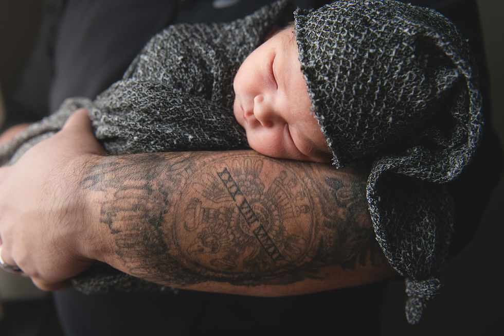 newborn on daddy's tattoo