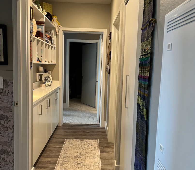 Childhood photos, books and collectibles, tell a story in this practical and fun hallway display.