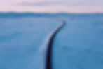 Long road in a snowy landscape representing the journey and adventure to self love