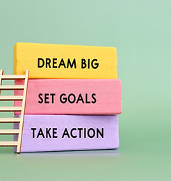 Wooden cubes with inspirational text - dream big, set goals, take action.jpg