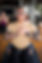 Male student with tattoo sleeves in meditation, hands over heart.