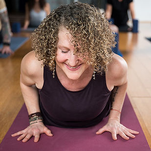Student in cobra pose at Three Birds Yoga Studio