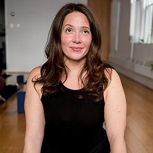 Student smiling in Upward Facing Dog at Three Birds Yoga.