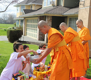 people offered foods to monk in the bowl