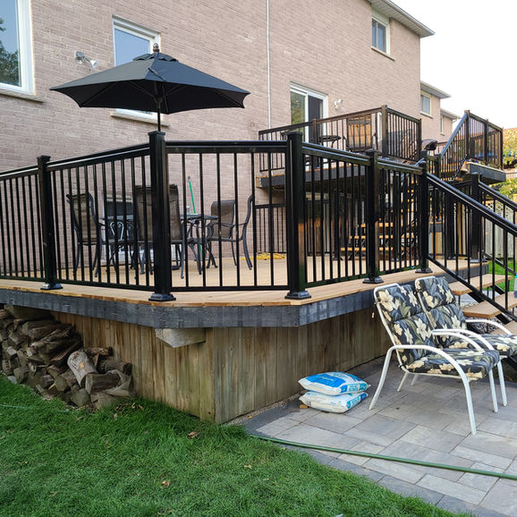 Barrie deck restoration with black railings and patio
