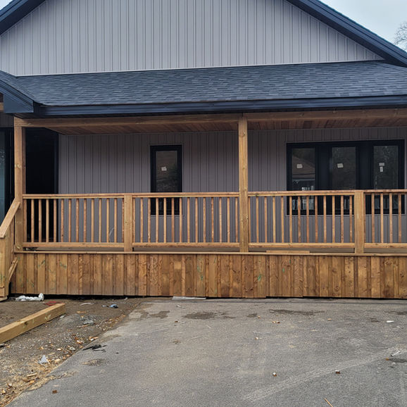 Newly built wooden deck on a gray house