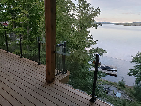 Frameless glass railing installation on a Lake Muskoka cottage deck.