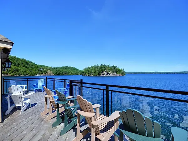 Framed glass railing installation on a Lake Muskoka cottage deck.