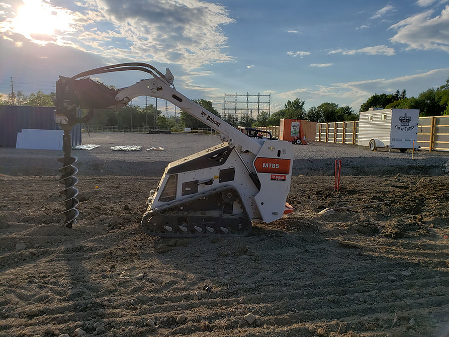 Bobcat auger digging for ez fences barrie
