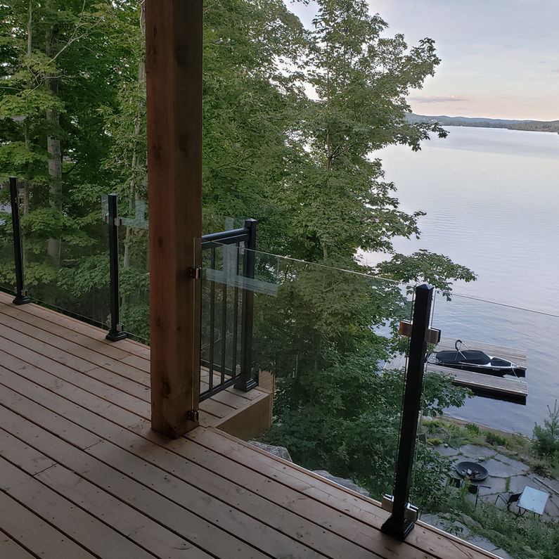 Deck with aluminum glass railings overlooking a lake