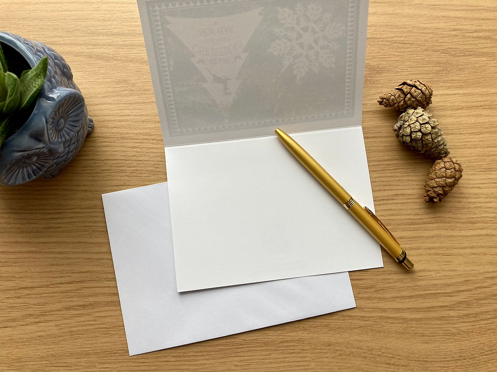 Thumbnail: Open blank Christmas card with golden pen and white envelope underneath