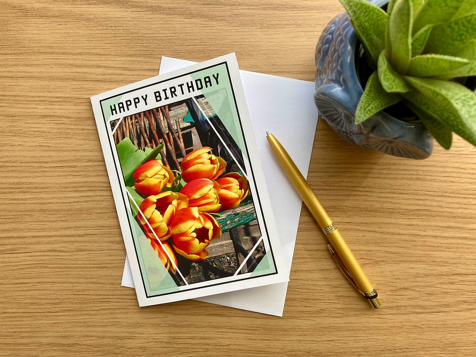Thumbnail: Happy Birthday card featuring tulips, white envelope underneath, golden pen, plant pot an the top right corner