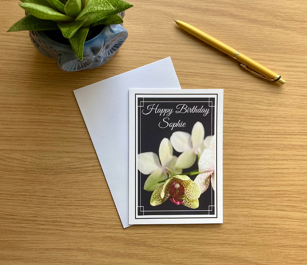 Thumbnail: Happy Birthday Sophie card with orchids laid out on the table, white envelope underneath