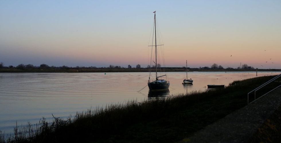 Sailboats at sunset, calm river