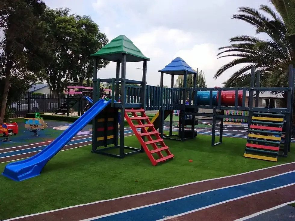 Eye-level view of a colorful jungle gym with swings and climbing gear