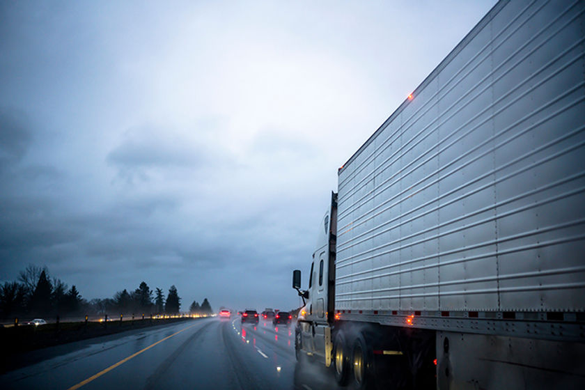 Truck on highway rain caution.jpg