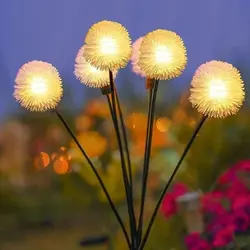 Solar-powered dandelion garden lights glowing at night outdoors