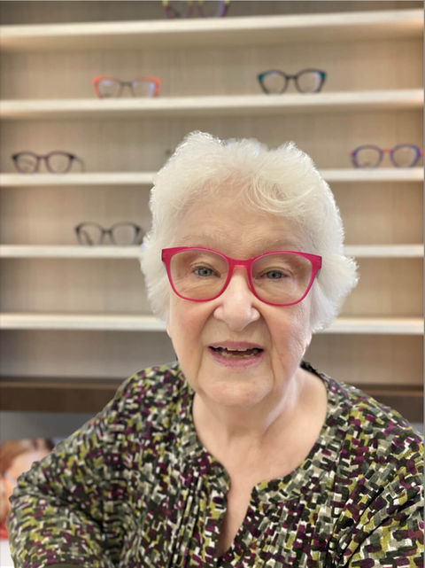banks opticians client, an elderly women modelling bright pink frames