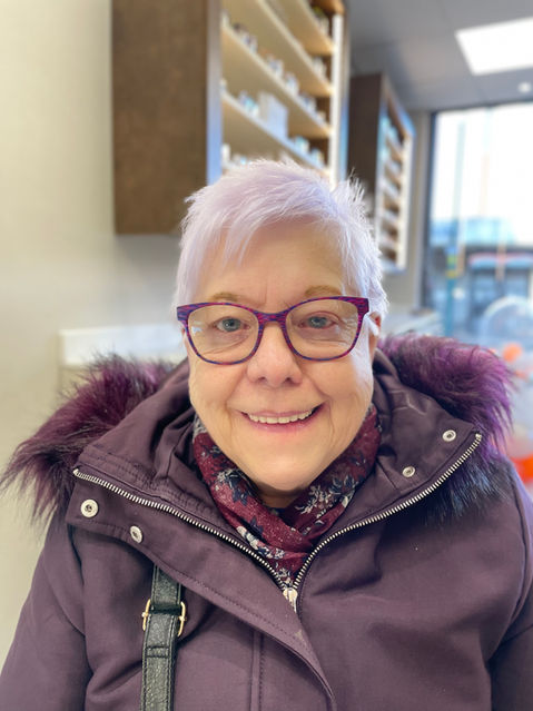 banks opticians client, a women modelling purple frames that match her light purple hair and purple coat
