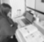 girl sat at desk with text books open and laptop