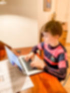 boy student tutored by Fortis Education wearing pink and blue striped t-shirt