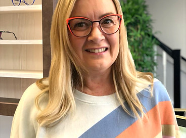 lady wearing upswept bright red frames with black rim