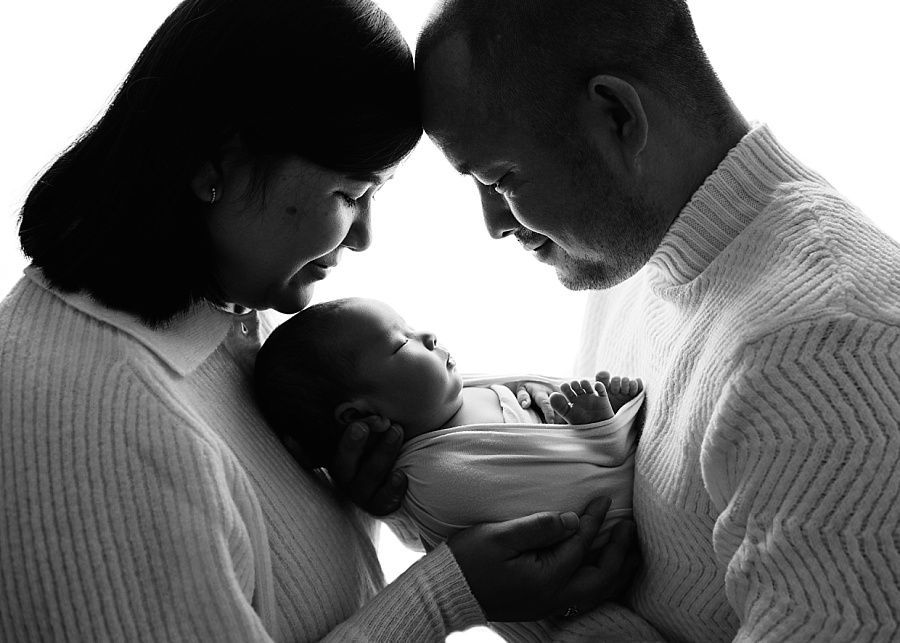 Andover newborn photoshoot, parents holding baby girl in black and white