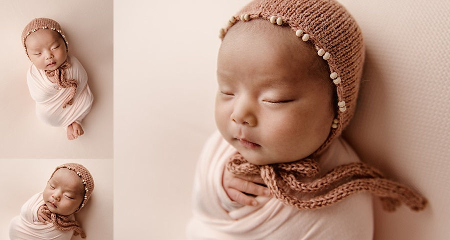 Newborn baby girl in sweet beaded bonnet