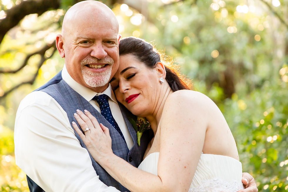 Cincinnati wedding photographer captures image of husband and wife hugging each other smiling for a picture.