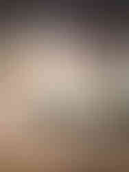 prayer stick with feathers on a brick wall