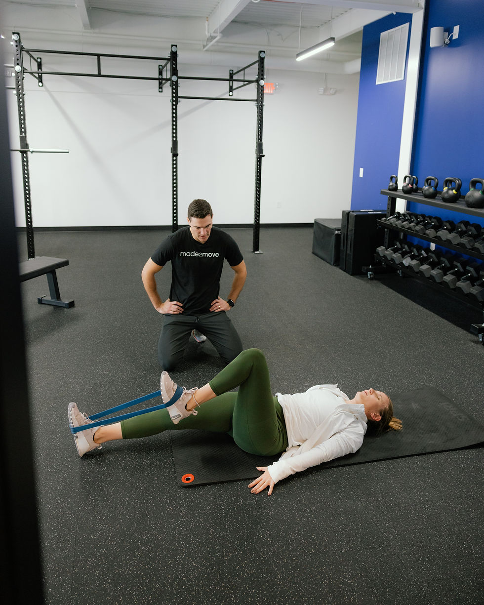 Charlotte patient working on progressive back loading with a physical therapist at Made2Move PT