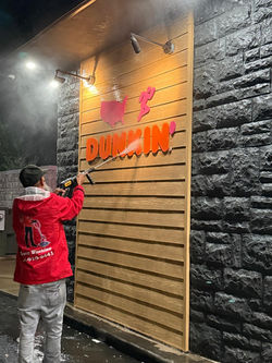 Commercial power washing on retail façade