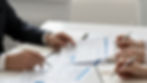 Hands reviewing clinical guidelines and regulatory documents to support decision-making in OAB and urinary incontinence treatment.