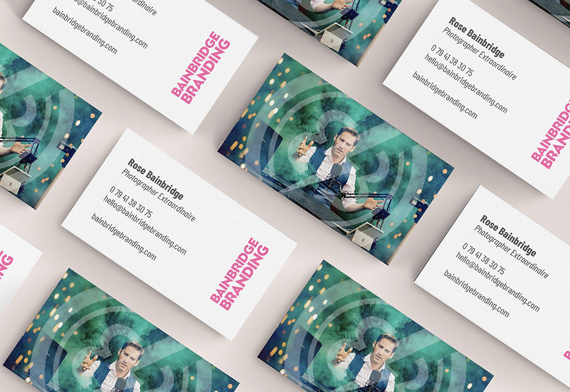 Flat lay of Bainbridge Branding business cards, showcasing the vibrant front design and contact details on the back.