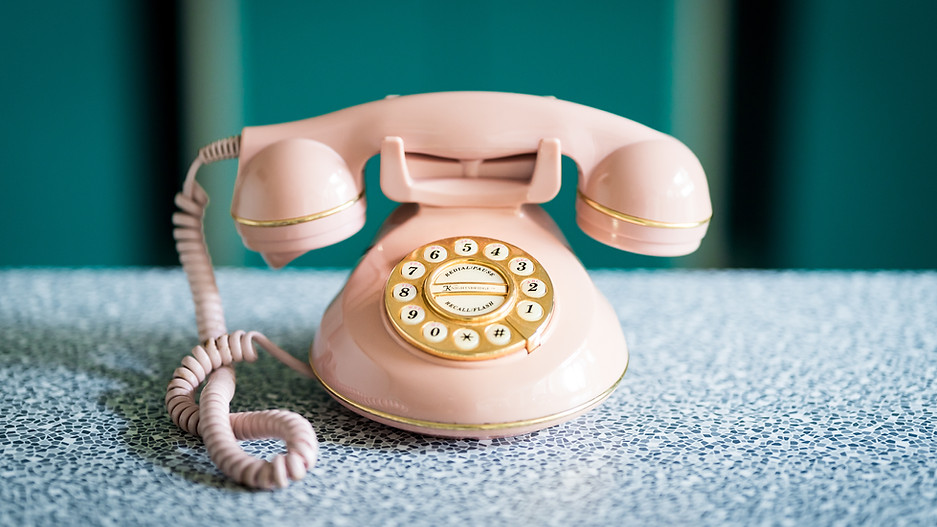 Vintage pink rotary telephone photograph with green background. Part of a photoshoot for Steph Chadwick's graphic + branding design business.