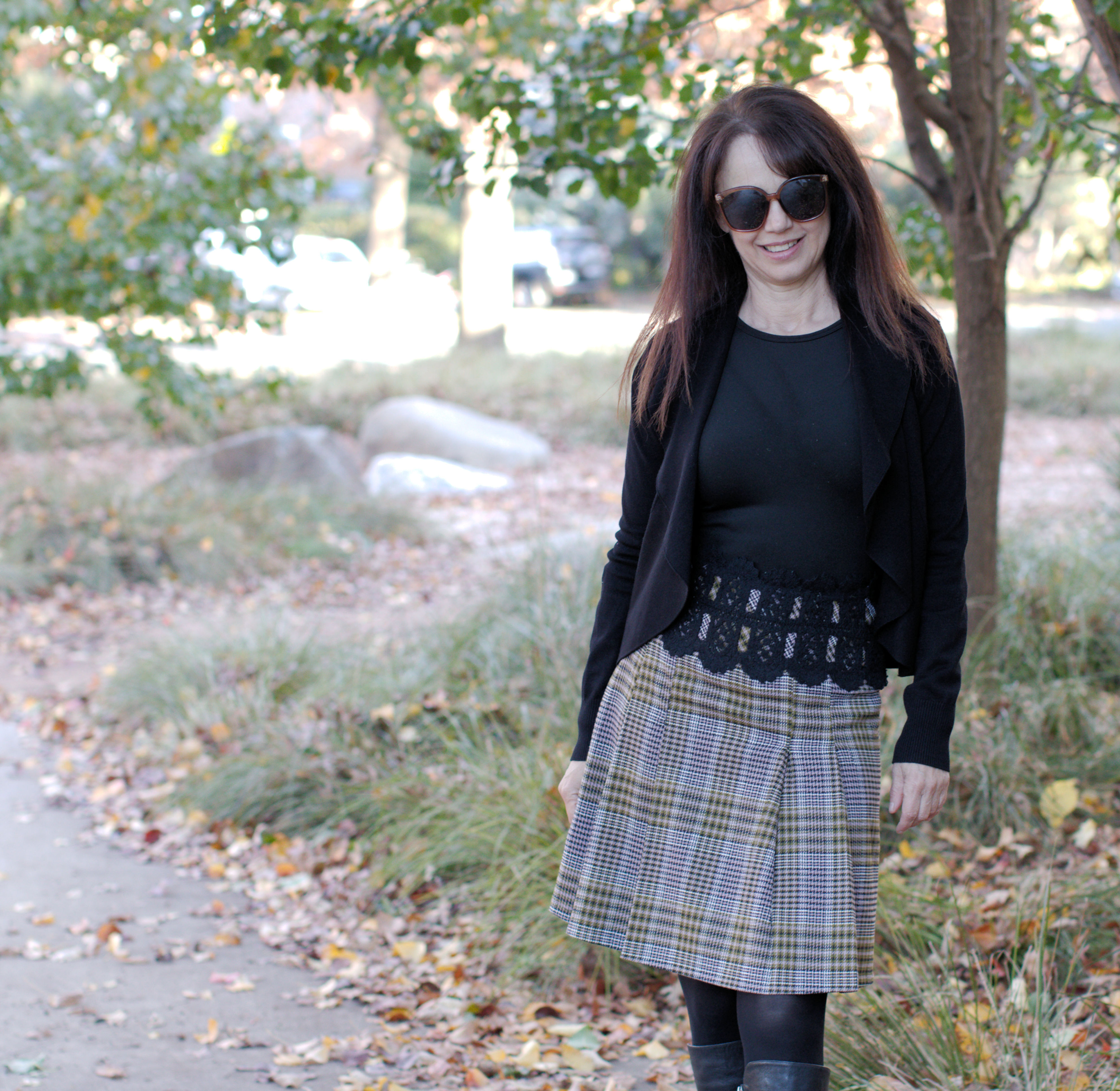 Model in plaid skirt / Front view with showing pleat detail.