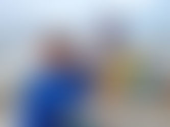 Children sitting on a boat enjoying hot dogs and drinks during a family fishing or boating trip, with water and other boats visible in the background.