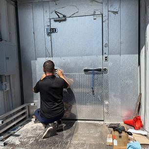 Commercial refrigeration technician servicing restaurant cooling equipment in Pensacola FL