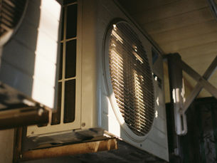 Outdoor air conditioner unit on a sunny day at a home needing AC repair in Pensacola FL