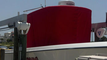 custom red marine canvas cover fitted on tank with industrial equipment in background
