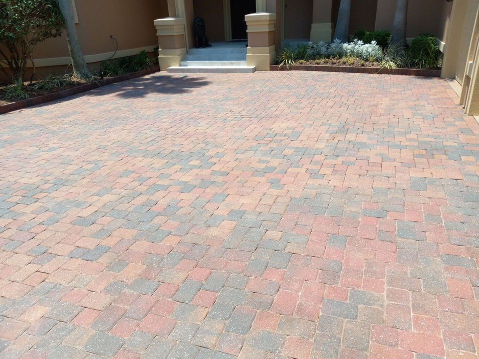 Vibrant and clean pavers brought back to life by 30A Power Washing and Paver Sealing. Restore your driveway's charm today!