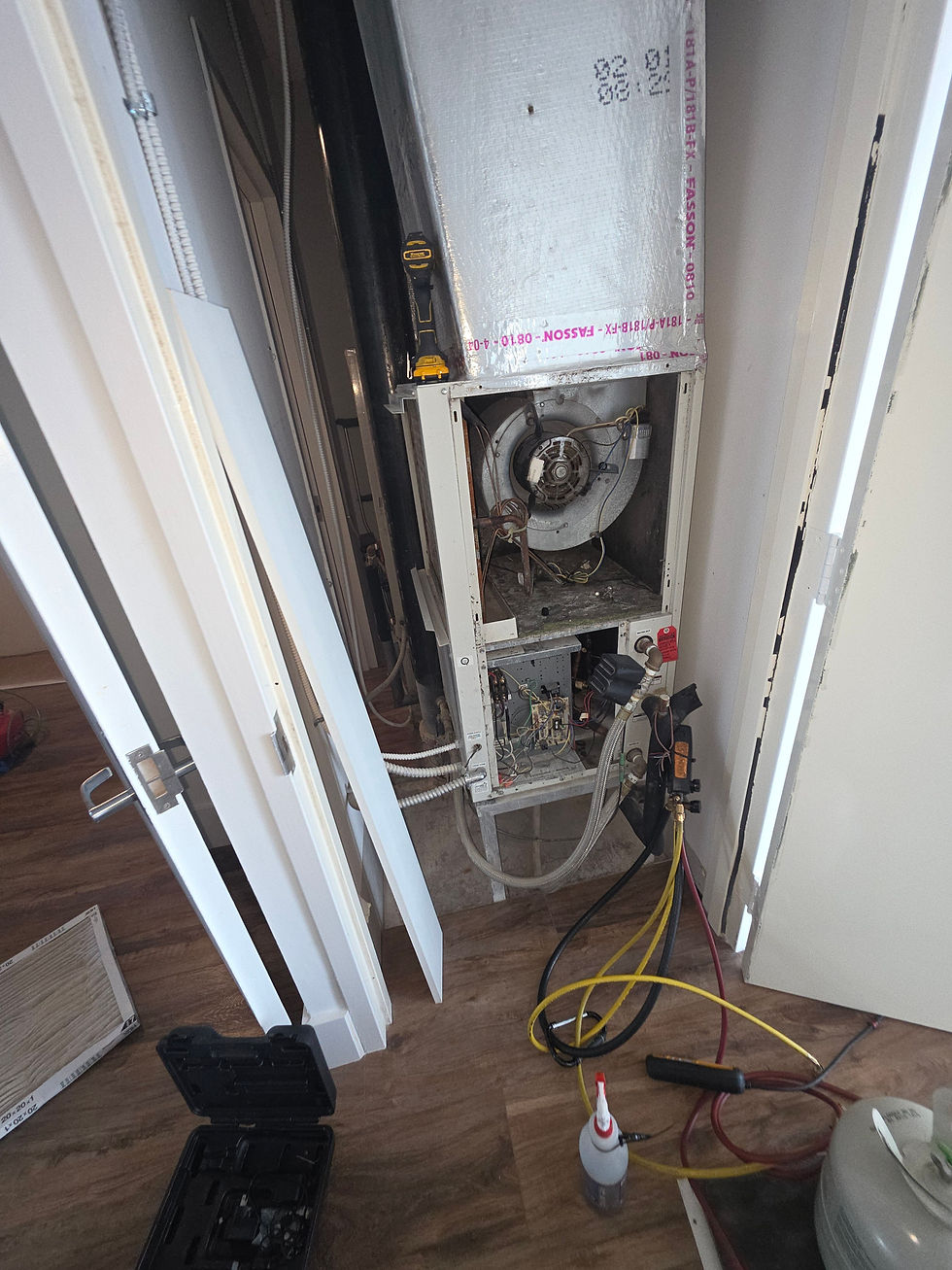 BW Air Conditioning technician working on an air handler during an AC repair service call in Fort Lauderdale, FL