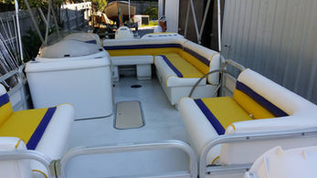 Custom boat interior seating with yellow, white, and gray marine upholstery design