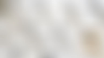 A range of pure essential oils from Lib's Aromatherapy laid out on a marble top with botanicals.