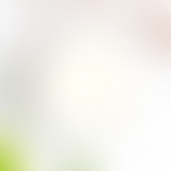 White soy candle with rose gold wick trimmer and candle snuffer on a wooden background, demonstrating proper candle care tools.